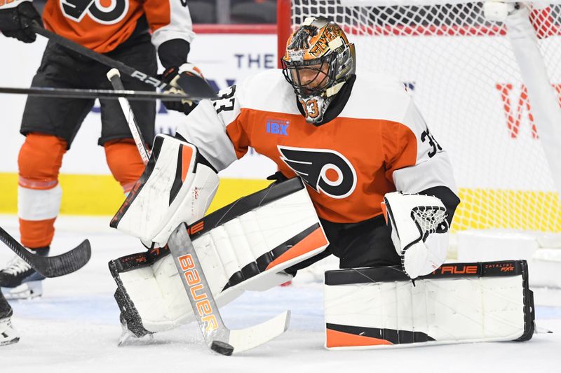 Sep 26, 2024; Philadelphia, Pennsylvania, USA; Philadelphia Flyers goaltender Samuel Ersson (33) makes a save against the New York Islanders during the first period at Wells Fargo Center. Mandatory Credit: Eric Hartline-Imagn Images