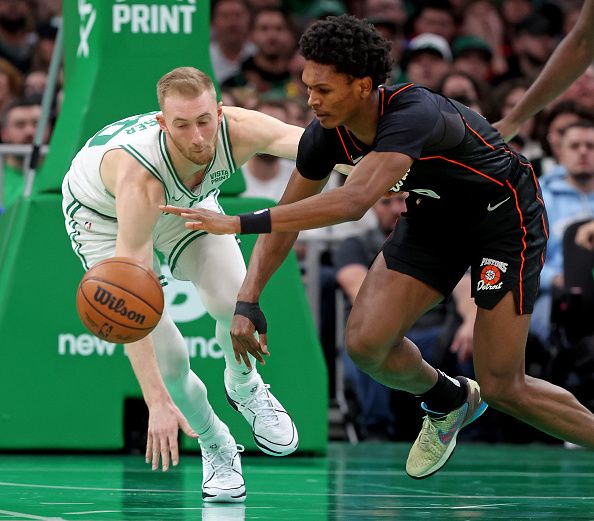 Boston, MA - December 28: Boston Celtics forward Sam Hauser #30 and Detroit Pistons forward Ausar Thompson #9 go after a loose ball during the first half. (Photo by Matt Stone/MediaNews Group/Boston Herald via Getty Images)