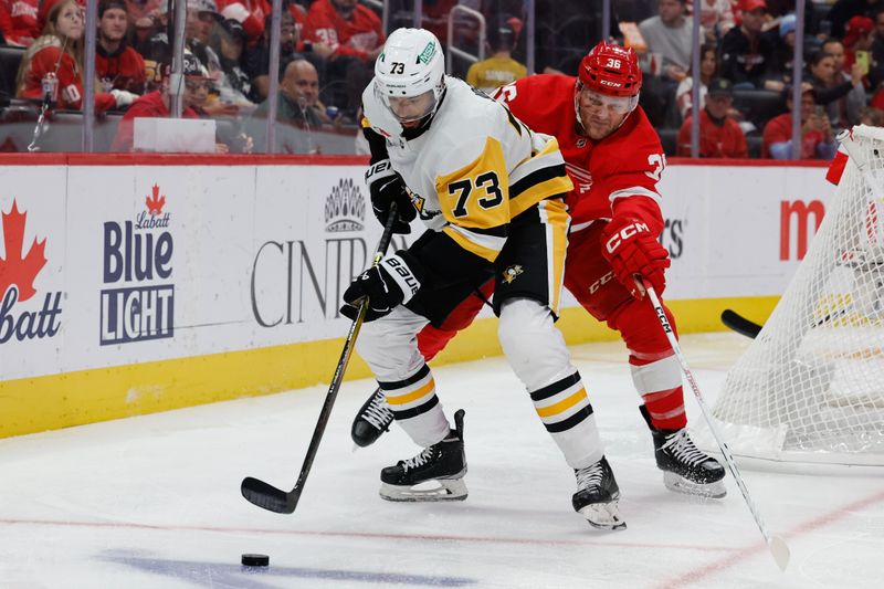 Oct 18, 2023; Detroit, Michigan, USA; Pittsburgh Penguins defenseman Pierre-Olivier Joseph (73) skates with the puck chased by Detroit Red Wings right wing Christian Fischer (36) in the second period at Little Caesars Arena. Mandatory Credit: Rick Osentoski-USA TODAY Sports