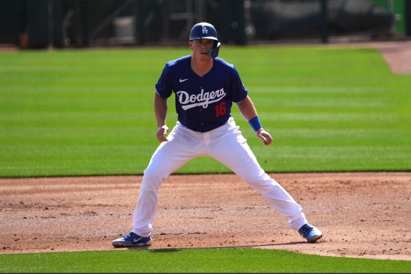 Feb 25, 2024; Phoenix, Arizona, USA; Los Angeles Dodgers catcher Will Smith (16) leads off first base against the Oakland Athletics during the first inning at Camelback Ranch-Glendale. Mandatory Credit: Joe Camporeale-USA TODAY Sports