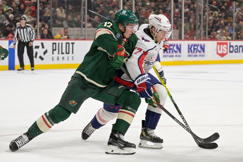 Jan 23, 2024; Saint Paul, Minnesota, USA;  Minnesota Wild forward Matt Boldy (12) and Washington Capitals forward T.J. Oshie (77) battle for position during the first period at Xcel Energy Center. Mandatory Credit: Nick Wosika-USA TODAY Sports