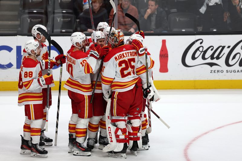 Dec 21, 2023; Anaheim, California, USA;  Calgary Flames goaltender Jacob Markstrom (25) celebrates a victory with teammates after beating the Anaheim Ducks 3-0 at Honda Center. Mandatory Credit: Kiyoshi Mio-USA TODAY Sports