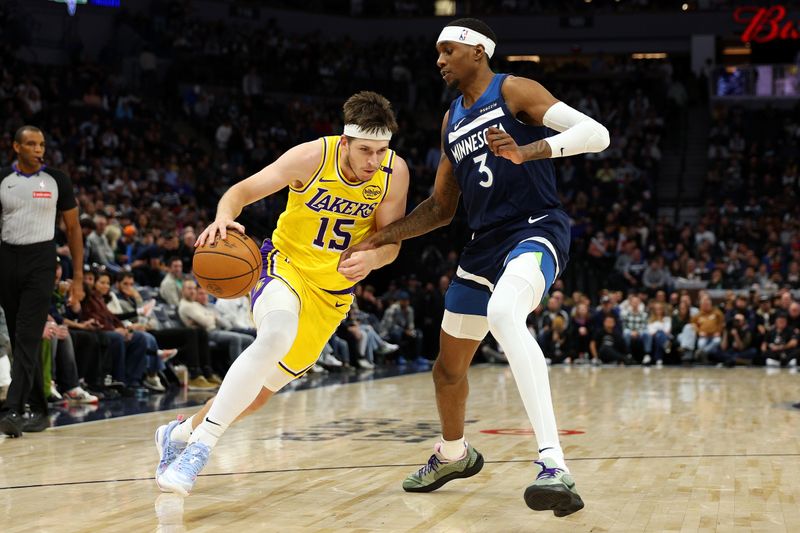 MINNEAPOLIS, MINNESOTA - DECEMBER 13: Austin Reaves #15 of the Los Angeles Lakers goes to the basket against Jaden McDaniels #3 of the Minnesota Timberwolves in the fourth quarter at Target Center on December 13, 2024 in Minneapolis, Minnesota. The Timberwolves defeated the Lakers 97-87. NOTE TO USER: User expressly acknowledges and agrees that, by downloading and or using this photograph, User is consenting to the terms and conditions of the Getty Images License Agreement. (Photo by David Berding/Getty Images)