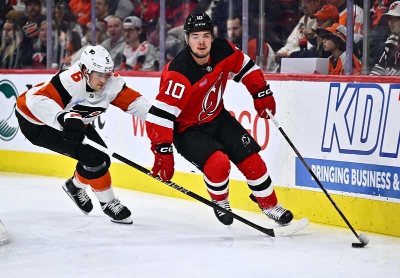 Apr 13, 2024; Philadelphia, Pennsylvania, USA; New Jersey Devils right wing Alexander Holtz (10) controls the puck against Philadelphia Flyers defenseman Travis Sanheim (6) in the second period at Wells Fargo Center. Mandatory Credit: Kyle Ross-USA TODAY Sports