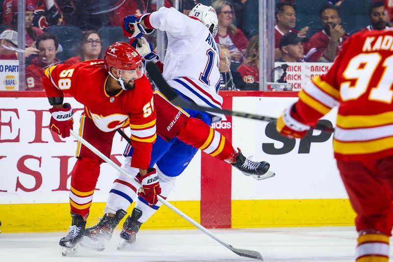 Mar 16, 2024; Calgary, Alberta, CAN; Calgary Flames defenseman Oliver Kylington (58) and Montreal Canadiens right wing Josh Anderson (17) battles for the puck during the third period at Scotiabank Saddledome. Mandatory Credit: Sergei Belski-USA TODAY Sports