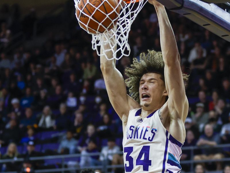 Feb 18, 2023; Seattle, Washington, USA; Washington Huskies center Braxton Meah (34) dunks against Oregon State Beavers center KC Ibekwe (24) during the second half at Alaska Airlines Arena at Hec Edmundson Pavilion. Mandatory Credit: Joe Nicholson-USA TODAY Sports