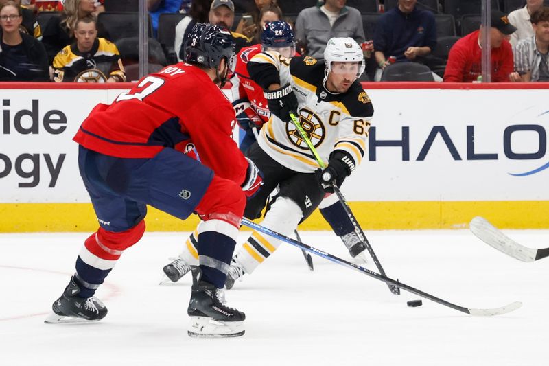 Oct 5, 2024; Washington, District of Columbia, USA; Boston Bruins left wing Brad Marchand (63) skates with the puck as Washington Capitals defenseman Matt Roy (3) defends in the second period at Capital One Arena. Mandatory Credit: Geoff Burke-Imagn Images