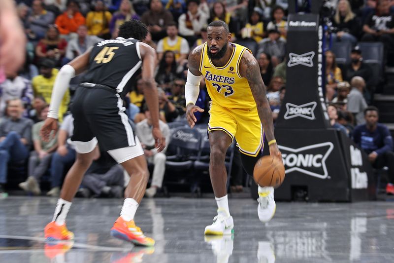 MEMPHIS, TENNESSEE - APRIL 12: LeBron James #23 of the Los Angeles Lakers handles the ball against GG Jackson #45 of the Memphis Grizzlies during the first half at FedExForum on April 12, 2024 in Memphis, Tennessee. NOTE TO USER: User expressly acknowledges and agrees that, by downloading and or using this photograph, User is consenting to the terms and conditions of the Getty Images License Agreement. (Photo by Justin Ford/Getty Images)