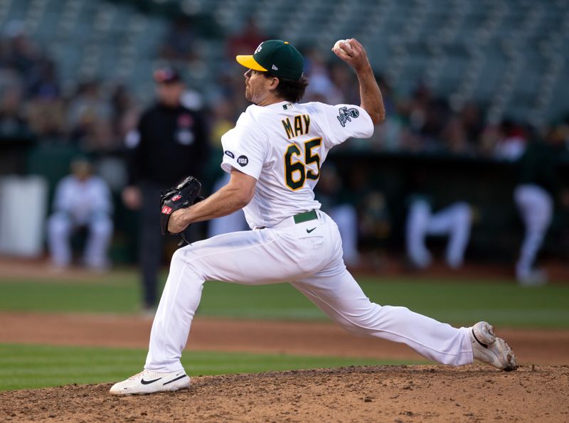 May 29, 2023; Oakland, California, USA; Oakland Athletics pitcher Trevor May (65) delivers a pitch against the Atlanta Braves during the ninth inning at Oakland-Alameda County Coliseum. Mandatory Credit: D. Ross Cameron-USA TODAY Sports