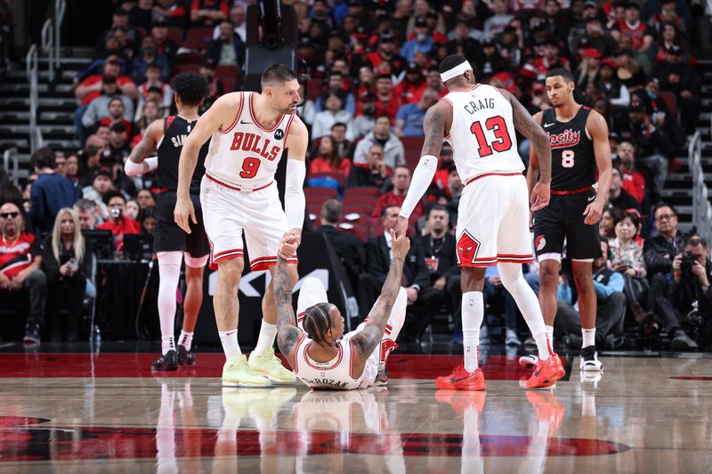 CHICAGO, IL - MARCH 18:  DeMar DeRozan #11 of the Chicago Bulls is helped up by Nikola Vucevic #9 and Torrey Craig #13 during the game against the Portland Trail Blazers on March 18, 2024 at United Center in Chicago, Illinois. NOTE TO USER: User expressly acknowledges and agrees that, by downloading and or using this photograph, User is consenting to the terms and conditions of the Getty Images License Agreement. Mandatory Copyright Notice: Copyright 2024 NBAE (Photo by Jeff Haynes/NBAE via Getty Images)