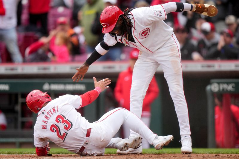 April 21, 2024; Cincinnati, Ohio, USA; Cincinnati Reds designated hitter Nick Martini (23) and Cincinnati Reds shortstop Elly De La Cruz (44), who both scored on a double by Cincinnati Reds first base Christian Encarnacion-Strand (33) (not pictured), react in the sixth inning of a baseball game against the Los Angeles Angels at Great American Ball Park. Mandatory Credit: Kareem Elgazzar/USA TODAY Sports via The Cincinnati Enquirer

