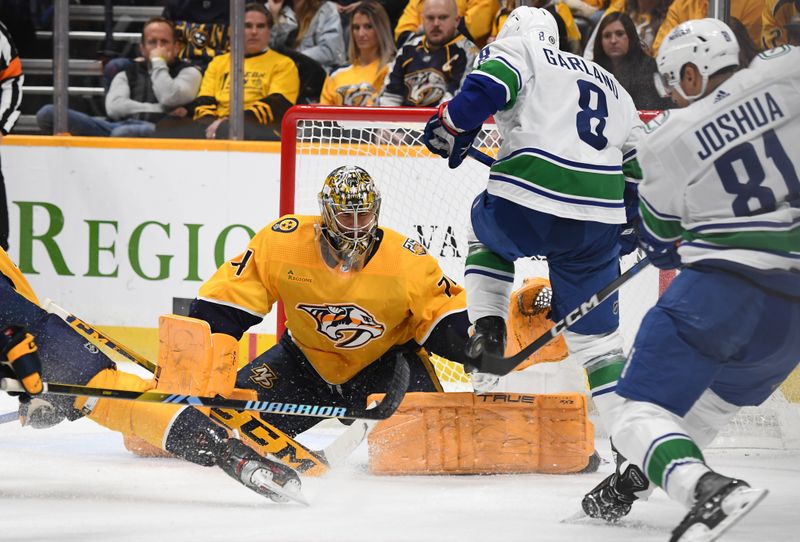 Dec 19, 2023; Nashville, Tennessee, USA; Nashville Predators goaltender Juuse Saros (74) makes a save on a shot by Vancouver Canucks center Dakota Joshua (81) with a screen from right wing Conor Garland (8) during the second period at Bridgestone Arena. Mandatory Credit: Christopher Hanewinckel-USA TODAY Sports