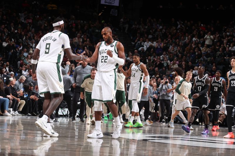 BROOKLYN, NY - DECEMBER 8: Khris Middleton #22 and Bobby Portis #9 of the Milwaukee Bucks high five during the game against the Brooklyn Nets on December 8, 2024 at Barclays Center in Brooklyn, New York. NOTE TO USER: User expressly acknowledges and agrees that, by downloading and or using this Photograph, user is consenting to the terms and conditions of the Getty Images License Agreement. Mandatory Copyright Notice: Copyright 2024 NBAE (Photo by Nathaniel S. Butler/NBAE via Getty Images)