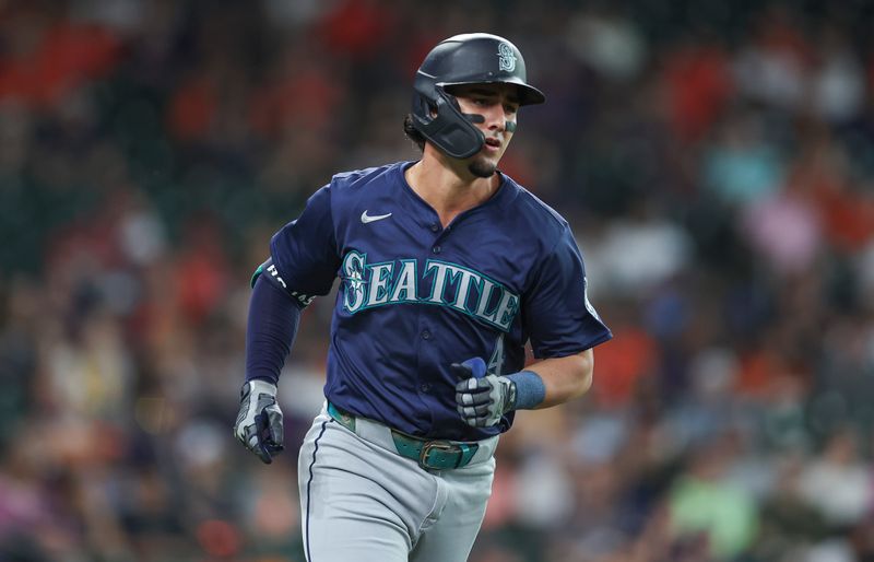 May 3, 2024; Houston, Texas, USA; Seattle Mariners third baseman Josh Rojas (4) runs to first base on a single during the first inning against the Houston Astros at Minute Maid Park. Mandatory Credit: Troy Taormina-USA TODAY Sports