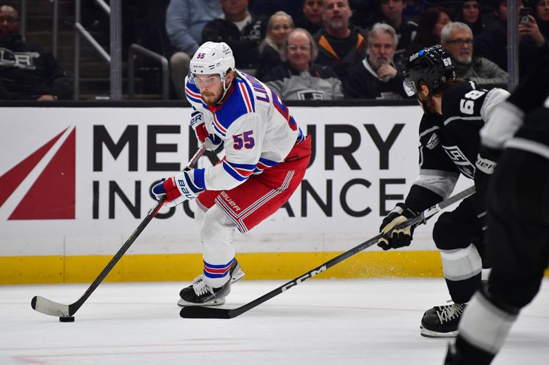 Jan 20, 2024; Los Angeles, California, USA; New York Rangers defenseman Ryan Lindgren (55) moves the puck against the Los Angeles Kings durng the third period at Crypto.com Arena. Mandatory Credit: Gary A. Vasquez-USA TODAY Sports