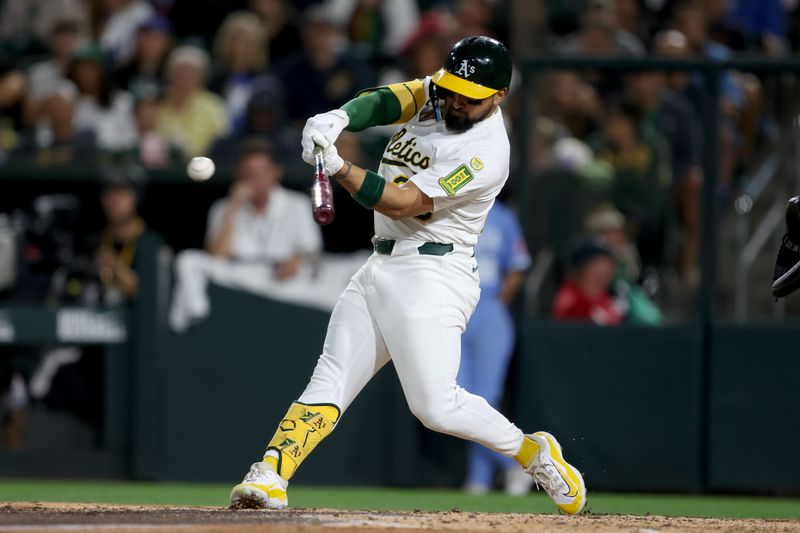 Sep 27, 2025; West Sacramento, California, USA; Athletics right fielder Carlos Cortes (26) hits an RBI double against the Kansas City Royals during the seventh inning at Sutter Health Park. Mandatory Credit: Dennis Lee-Imagn Images