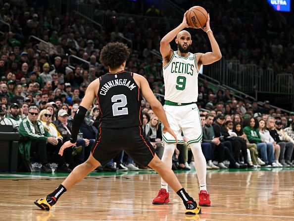 BOSTON, MASSACHUSETTS - DECEMBER 28: Derrick White #9 of the Boston Celtics looks to pass the ball around Cade Cunningham #2 of the Detroit Pistons during the second quarter at TD Garden on December 28, 2023 in Boston, Massachusetts. NOTE TO USER: User expressly acknowledges and agrees that, by downloading and or using this photograph, User is consenting to the terms and conditions of the Getty Images License Agreement. (Photo by Brian Fluharty/Getty Images)