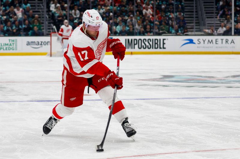 Feb 19, 2024; Seattle, Washington, USA; Detroit Red Wings right wing Daniel Sprong (17) shoots the puck against the Seattle Kraken during the first period at Climate Pledge Arena. Mandatory Credit: Joe Nicholson-USA TODAY Sports