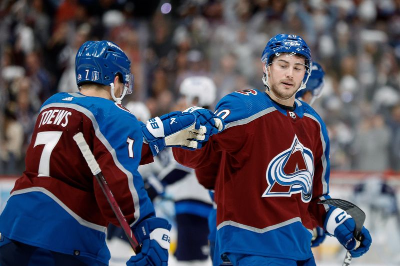 Apr 26, 2024; Denver, Colorado, USA; Colorado Avalanche center Ross Colton (20) celebrates his goal with defenseman Devon Toews (7) in the third period against the Winnipeg Jets in game three of the first round of the 2024 Stanley Cup Playoffs at Ball Arena. Mandatory Credit: Isaiah J. Downing-USA TODAY Sports