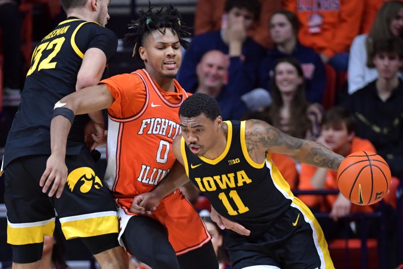 Feb 24, 2024; Champaign, Illinois, USA;  Iowa Hawkeyes guard Tony Perkins (11) moves the ball around Illinois Fighting Illini guard Terrence Shannon Jr. (0) during the first half at State Farm Center. Mandatory Credit: Ron Johnson-USA TODAY Sports