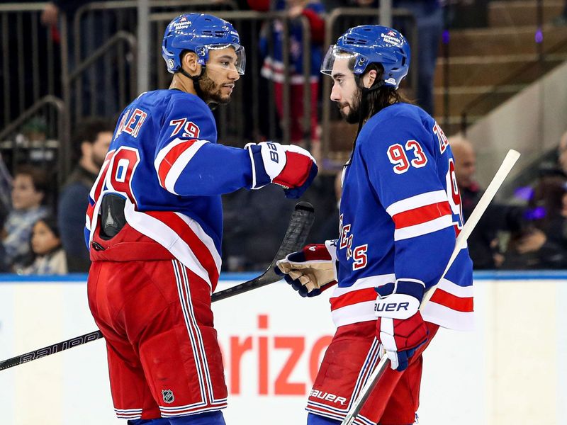 Jan 18, 2025; New York, New York, USA; New York Rangers defenseman K'Andre Miller (79) celebrates with center Mika Zibanejad (93) after a 1-0 shootout win against the Columbus Blue Jackets at Madison Square Garden. Mandatory Credit: Danny Wild-Imagn Images