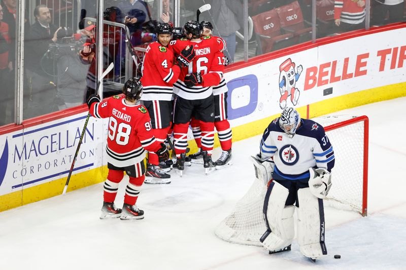 Feb 23, 2024; Chicago, Illinois, USA; Chicago Blackhawks center Tyler Johnson (90) celebrates with teammates after scoring against the Winnipeg Jets during the third period at United Center. Mandatory Credit: Kamil Krzaczynski-USA TODAY Sports