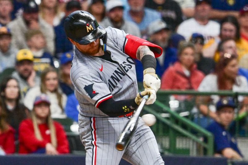 May 17, 2025; Milwaukee, Wisconsin, USA;  Minnesota Twins catcher Christian Vazquez (8) drives in a run with a base hit in the second inning against the Milwaukee Brewers at American Family Field. Mandatory Credit: Benny Sieu-Imagn Images