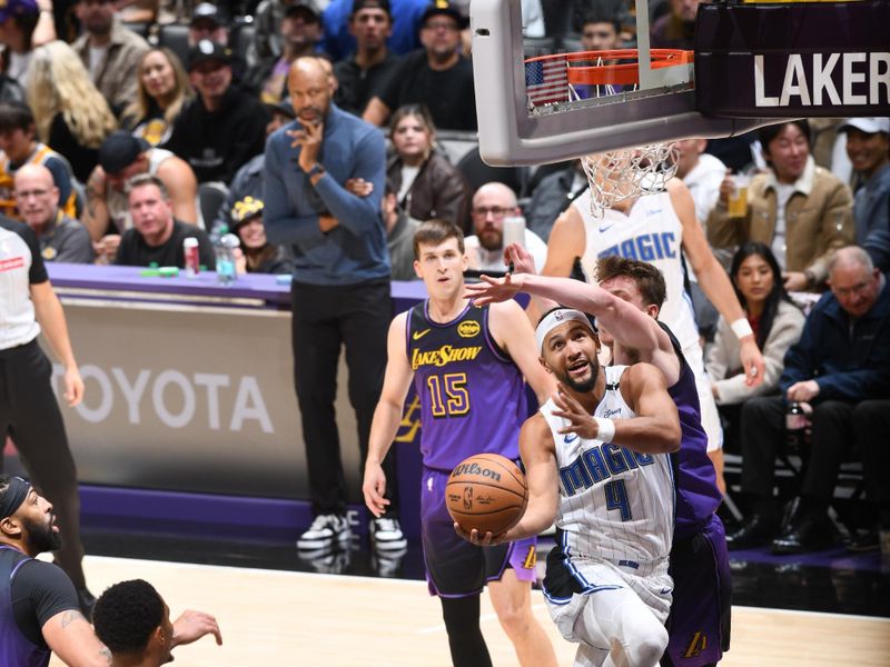 LOS ANGELES, CA - NOVEMBER 21: Jalen Suggs #4 of the Orlando Magic drives to the basket during the game against the Los Angeles Lakers on November 21, 2024 at Crypto.Com Arena in Los Angeles, California. NOTE TO USER: User expressly acknowledges and agrees that, by downloading and/or using this Photograph, user is consenting to the terms and conditions of the Getty Images License Agreement. Mandatory Copyright Notice: Copyright 2024 NBAE (Photo by Adam Pantozzi/NBAE via Getty Images)