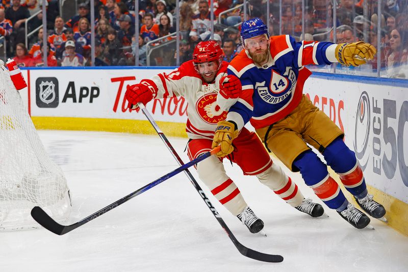 Feb 24, 2024; Edmonton, Alberta, CAN; Edmonton Oilers /defensemen Mattias Ekholm (14) and Calgary Flames forward Name Kadri (91) battle for a loose puck during the second period at Rogers Place. Mandatory Credit: Perry Nelson-USA TODAY Sports