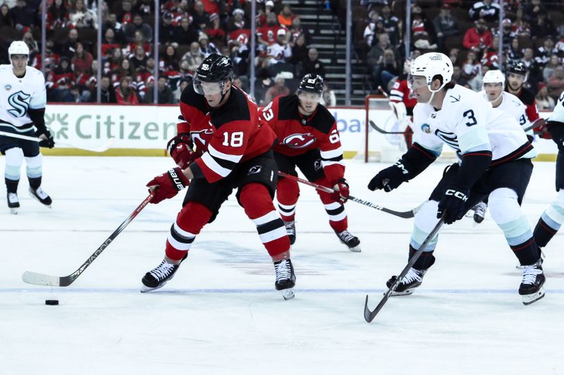 Feb 12, 2024; Newark, New Jersey, USA; New Jersey Devils left wing Ondrej Palat (18) skates with the puck as Seattle Kraken defenseman Will Borgen (3) defends during the second period at Prudential Center. Mandatory Credit: John Jones-USA TODAY Sports