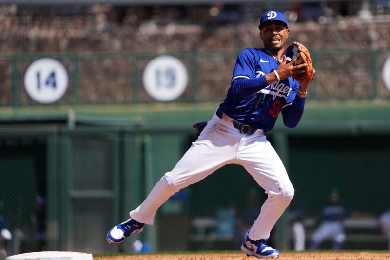 Mar 10, 2024; Phoenix, Arizona, USA; Los Angeles Dodgers infielder Mookie Betts (50) fields a throw against the Arizona Diamondbacks during the second inning at Camelback Ranch-Glendale. Mandatory Credit: Joe Camporeale-USA TODAY Sports