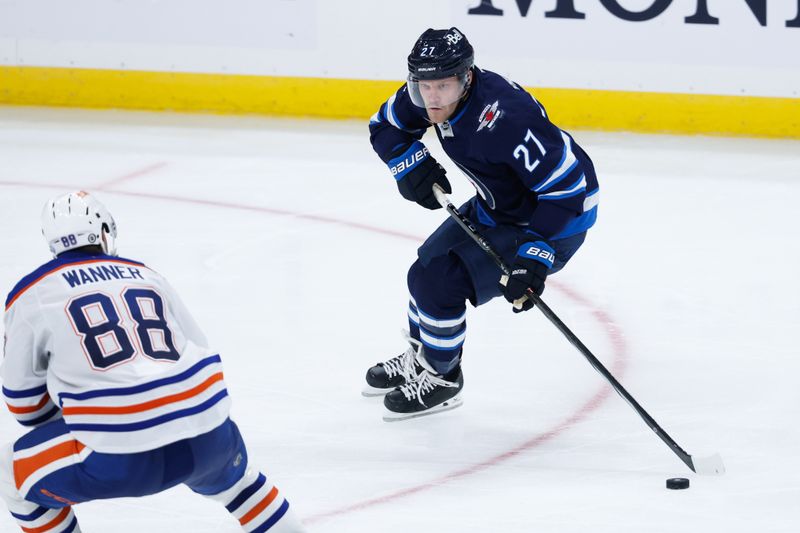 Sep 25, 2024; Winnipeg, Manitoba, CAN; Winnipeg Jets forward Nikolaj Ehlers (27) skates in on Edmonton Oilers defenseman Max Wanner (88) during the third period at Canada Life Centre. Mandatory Credit: Terrence Lee-Imagn Images