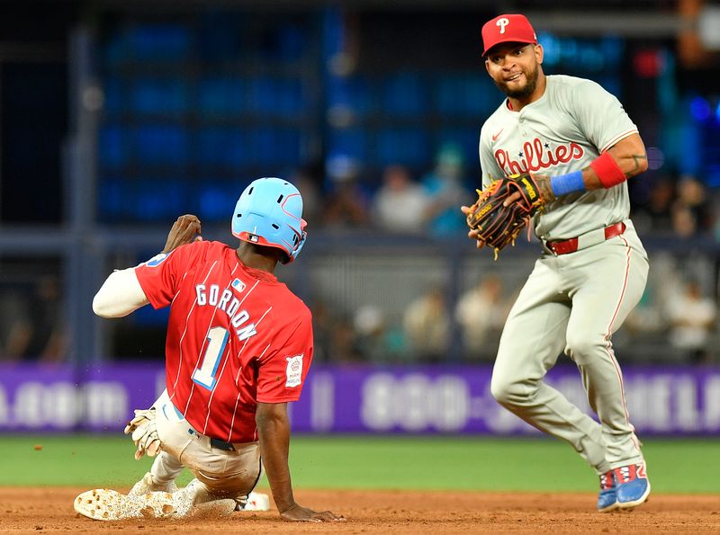 May 11, 2024; Miami, Florida, USA;  Philadelphia Phillies shortstop Edmundo Sosa (33) completes a force out against Miami Marlins outfielder Nick Gordon (1) during the ninth inning at loanDepot Park. Mandatory Credit: Michael Laughlin-USA TODAY Sports