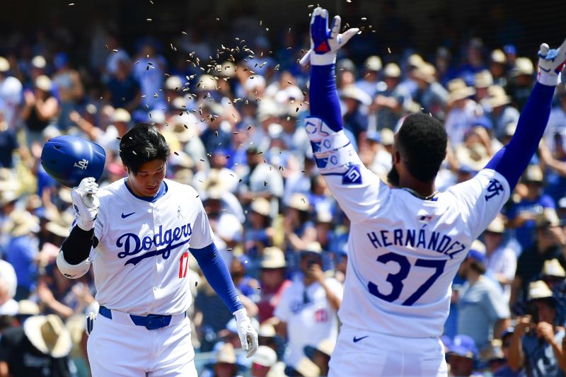 Jun 16, 2024; Los Angeles, California, USA; Los Angeles Dodgers designated hitter Shohei Ohtani (17) is greeted by left fielder Teoscar Hernández (37) after hitting a solo home run against the Kansas City Royals during the sixth inning at Dodger Stadium. Mandatory Credit: Gary A. Vasquez-USA TODAY Sports