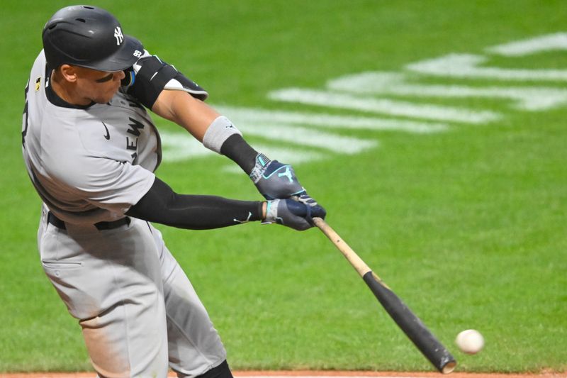 Apr 22, 2025; Cleveland, Ohio, USA; New York Yankees right fielder Aaron Judge (99) singles in the eighth inning against the Cleveland Guardians at Progressive Field. Mandatory Credit: David Richard-Imagn Images