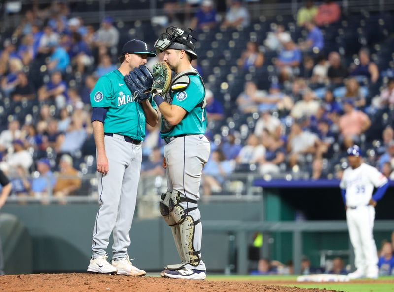 Sep 16, 2025; Kansas City, Missouri, USA; Seattle Mariners catcher Cal Raleigh (29) and relief pitcher Luke Jackson (77) visit at the mound during the eighth inning against the Kansas City Royals at Kauffman Stadium. Mandatory Credit: Scott Sewell-Imagn Images