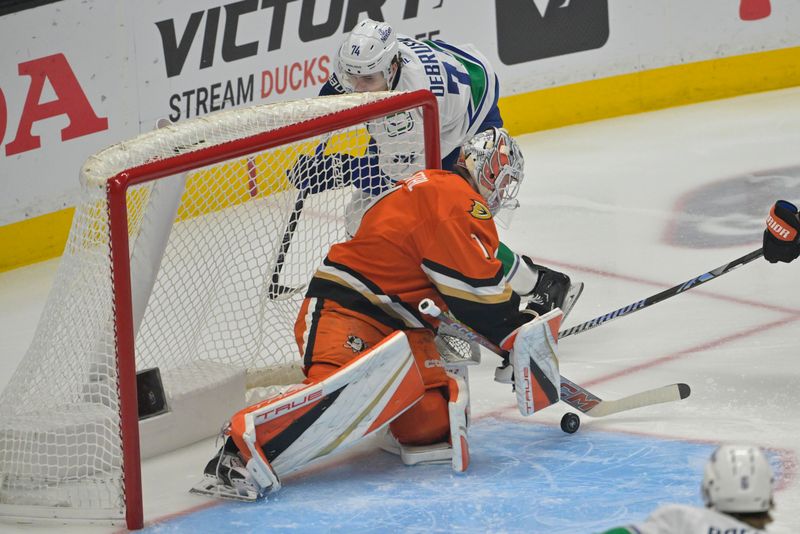 Nov 5, 2024; Anaheim, California, USA; Anaheim Ducks goaltender Lukas Dostal (1) makes a save off a shot by Vancouver Canucks left wing Jake DeBrusk (74) in the first period at Honda Center. Mandatory Credit: Jayne Kamin-Oncea-Imagn Images