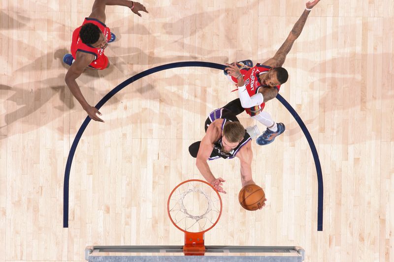 NEW ORLEANS, LA - DECEMBER 12: Domantas Sabonis #11 of the Sacramento Kings drives to the basket during the game against the New Orleans Pelicans on December 12, 2024 at the Smoothie King Center in New Orleans, Louisiana. NOTE TO USER: User expressly acknowledges and agrees that, by downloading and or using this Photograph, user is consenting to the terms and conditions of the Getty Images License Agreement. Mandatory Copyright Notice: Copyright 2024 NBAE (Photo by Layne Murdoch Jr./NBAE via Getty Images)