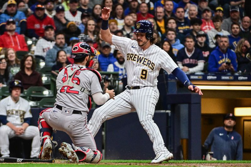 Apr 22, 2023; Milwaukee, Wisconsin, USA; Milwaukee Brewers third baseman Brian Anderson (9) is tagged out by Boston Red Sox catcher Connor Wong (12) while trying to score in the second inning at American Family Field. Mandatory Credit: Benny Sieu-USA TODAY Sports