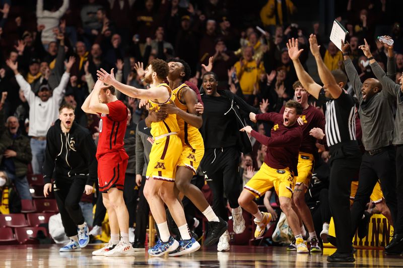 Mar 2, 2023; Minneapolis, Minnesota, USA; Minnesota Golden Gophers forward Jamison Battle is mobbed by teammates after his game-winning shot against the Rutgers Scarlet Knights during the second half at Williams Arena. Mandatory Credit: Matt Krohn-USA TODAY Sports