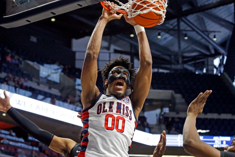 Jan 14, 2023; Oxford, Mississippi, USA; Mississippi Rebels forward Jayveous McKinnis (0) dunks against the Georgia Bulldogs during the second half at The Sandy and John Black Pavilion at Ole Miss. Mandatory Credit: Petre Thomas-USA TODAY Sports