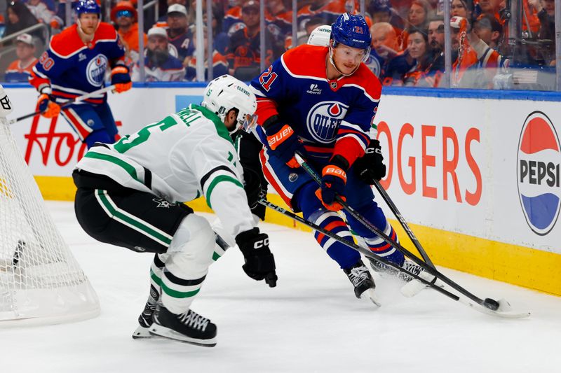 May 25, 2025; Edmonton, Alberta, CAN; Edmonton Oilers center Trent Frederic (21) keeps the puck away from Dallas Stars center Colin Blackwell (15) during the first period in game three of the Western Conference Final of the 2025 Stanley Cup Playoffs at Rogers Place. Mandatory Credit: Perry Nelson-Imagn Images