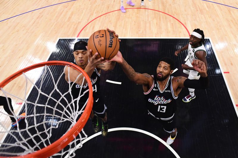 LOS ANGELES, CA - FEBRUARY 10: Paul George #13 of the LA Clippers rebounds the ball during the game against the Milwaukee Bucks on February 10, 2023 at Crypto.Com Arena in Los Angeles, California. NOTE TO USER: User expressly acknowledges and agrees that, by downloading and/or using this Photograph, user is consenting to the terms and conditions of the Getty Images License Agreement. Mandatory Copyright Notice: Copyright 2023 NBAE (Photo by Adam Pantozzi/NBAE via Getty Images)