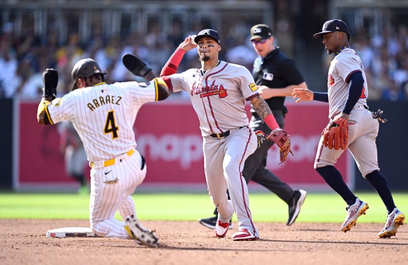 Jul 13, 2024; San Diego, California, USA; Atlanta Braves shortstop Orlando Arcia (11) throws to first base after forcing out San Diego Padres first baseman Luis Arraez (4) at second base to complete a double play during the third inning at Petco Park. Mandatory Credit: Orlando Ramirez-USA TODAY Sports 