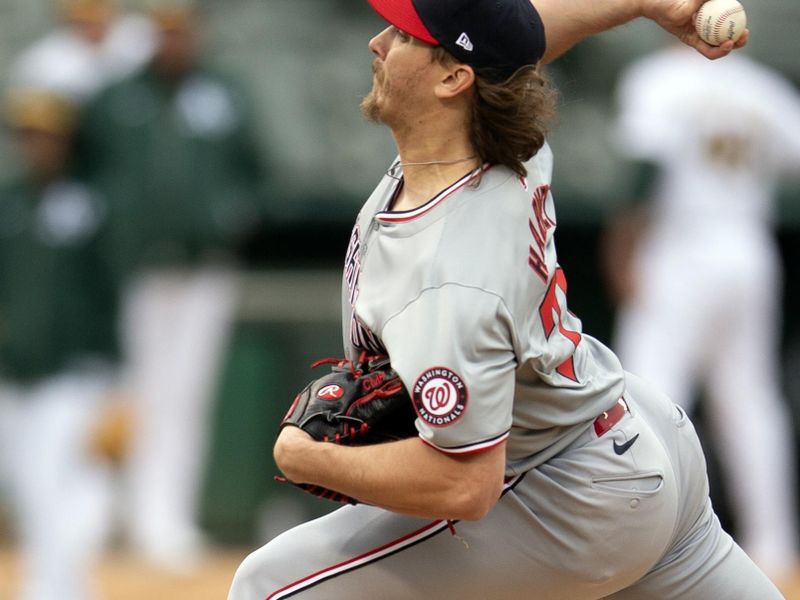 Apr 13, 2024; Oakland, California, USA; Washington Nationals pitcher Hunter Harvey (73) delivers a pitch against the Oakland Athletics during the eighth inning at Oakland-Alameda County Coliseum. Mandatory Credit: D. Ross Cameron-USA TODAY Sports
