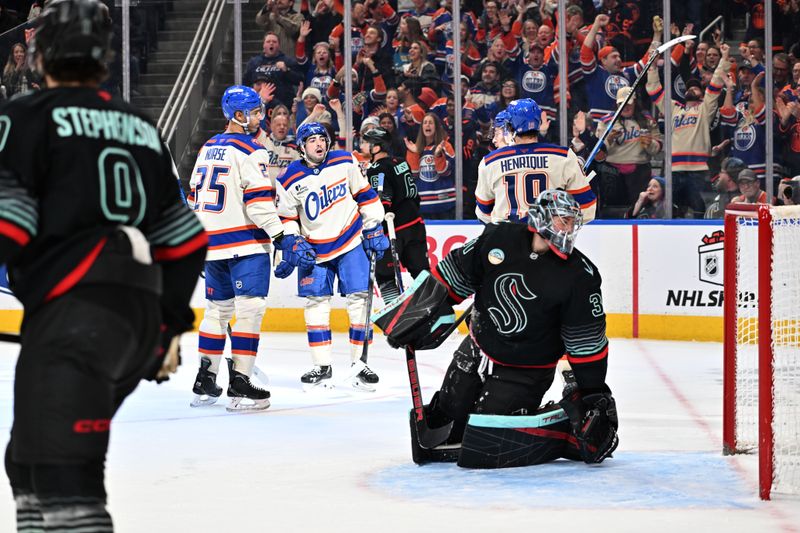Dec 4, 2025; Edmonton, Alberta, CAN;  Edmonton Oilers defenseman Darnell Nurse (25) with Oilers center Adam Henrique (19) and Oilers left winger Andrew Mangiapane (88) celebrate a goal on Seattle Kraken goalie Phillip Grubauer (31) during the third period at Rogers Place. Mandatory Credit: Walter Tychnowicz-Imagn Images