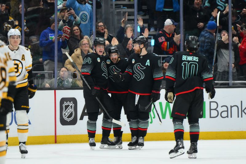 Jan 6, 2026; Seattle, Washington, USA; The Seattle Kraken celebrate after a goal scored by right wing Kaapo Kakko (84) during the third period against the Boston Bruins at Climate Pledge Arena. Mandatory Credit: Steven Bisig-Imagn Images