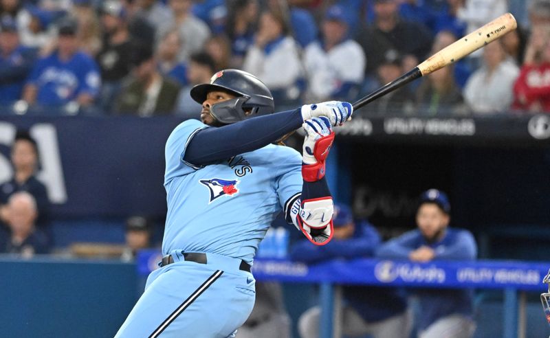 Sep 14, 2023; Toronto, Ontario, CAN;   Toronto Blue Jays first baseman Vladimir Guerrero Jr. (27) hits a two run home run against the Texas Rangers in the first inning at Rogers Centre. Mandatory Credit: Dan Hamilton-USA TODAY Sports