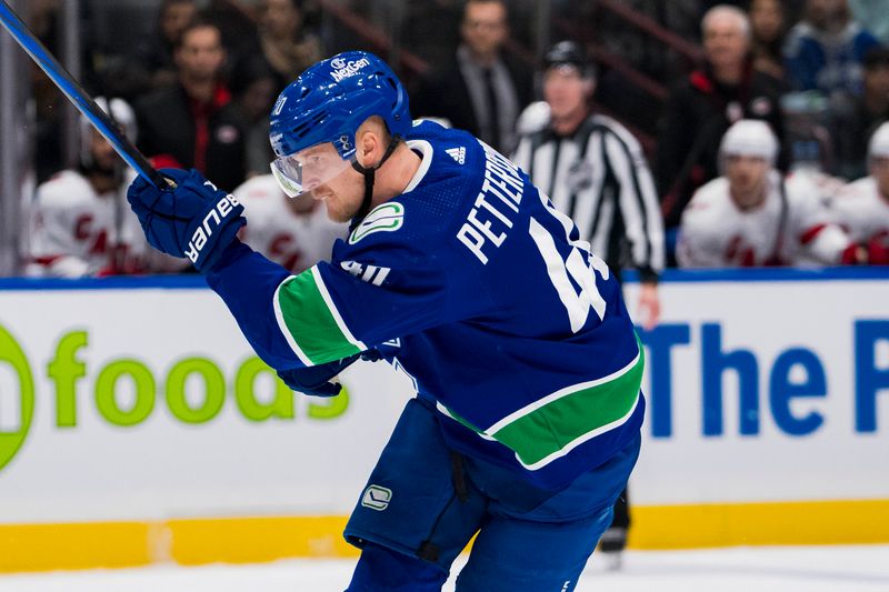 Dec 9, 2023; Vancouver, British Columbia, CAN; Vancouver Canucks forward Elias Pettersson (40) shoots against the Carolina Hurricanes  in the first period at Rogers Arena. Mandatory Credit: Bob Frid-USA TODAY Sports