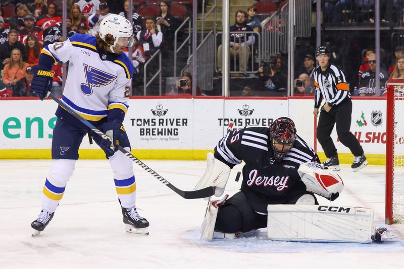 Nov 27, 2024; Newark, New Jersey, USA; New Jersey Devils goaltender Jacob Markstrom (25) makes a save against the St. Louis Blues during the third period at Prudential Center. Mandatory Credit: Ed Mulholland-Imagn Images